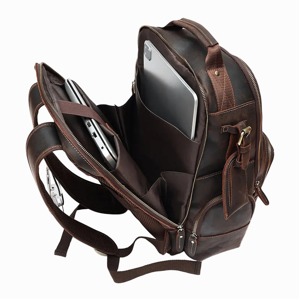 Handmade Brown Sheepskin leather backpack with compartments and a laptop inside on a white background
