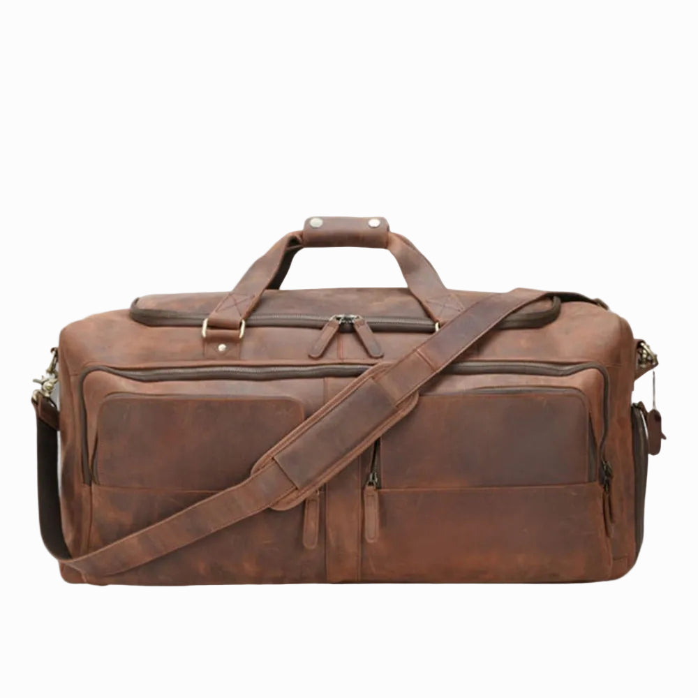 vintage Brown leather duffel bag with shoulder strap on a white background