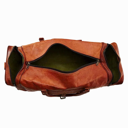 Brown leather travel duffel bag on a white background