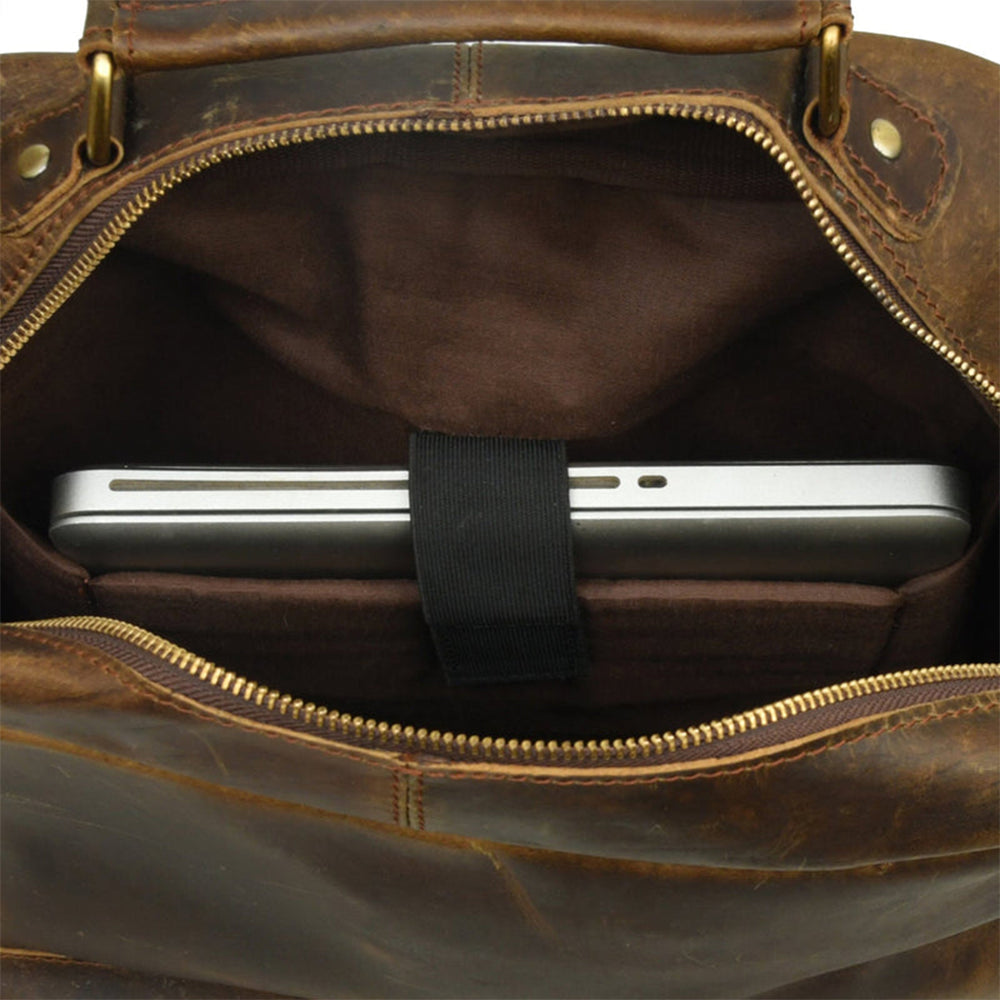 distressed Brown vintage Brown leather bag with a smartphone inside, showing gold zipper details.