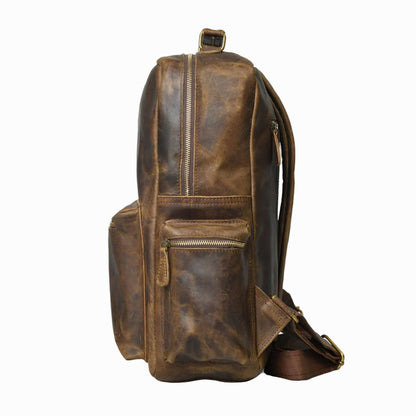 side view of distressed Brown vintage Brown leather backpack on a white background