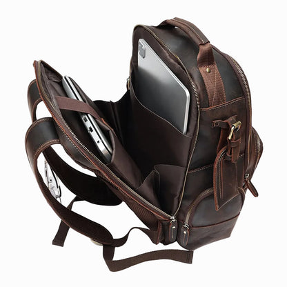 Handmade Brown Sheepskin leather backpack with compartments and a laptop inside on a white background