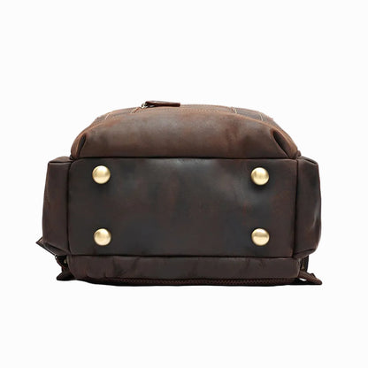 Handmade Brown Sheepskin leather backpack with gold buttons on a light gray background