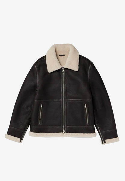Black leather sheepskin shearling jacket with cream shearling collar and cuffs on a white background