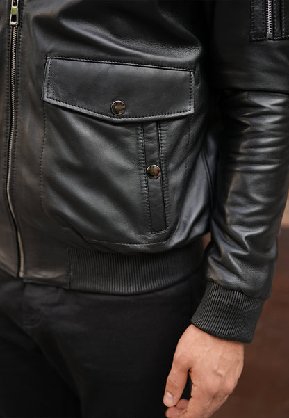Close-up of a black sheepskin shearling coat, a leather jacket with buttons, and a zipper.