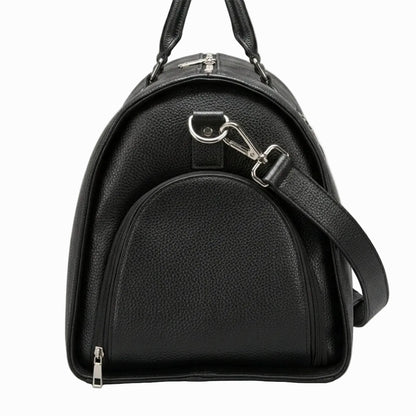 Vintage Black leather duffle bag with a shoulder strap on a light background