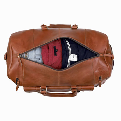 Vintage Brown Genuine Leather Travel Duffle Bag with clothes spilling out on a white background