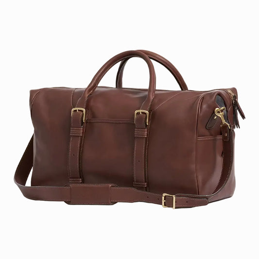 side view of Brown leather travel and gym duffel bag on a plain background