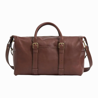 Brown vintage leather duffel bag with gold buckles on a plain background