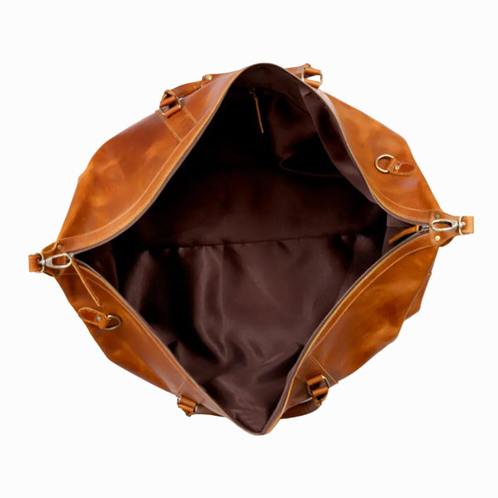 Brown leather bag with open top on a white background